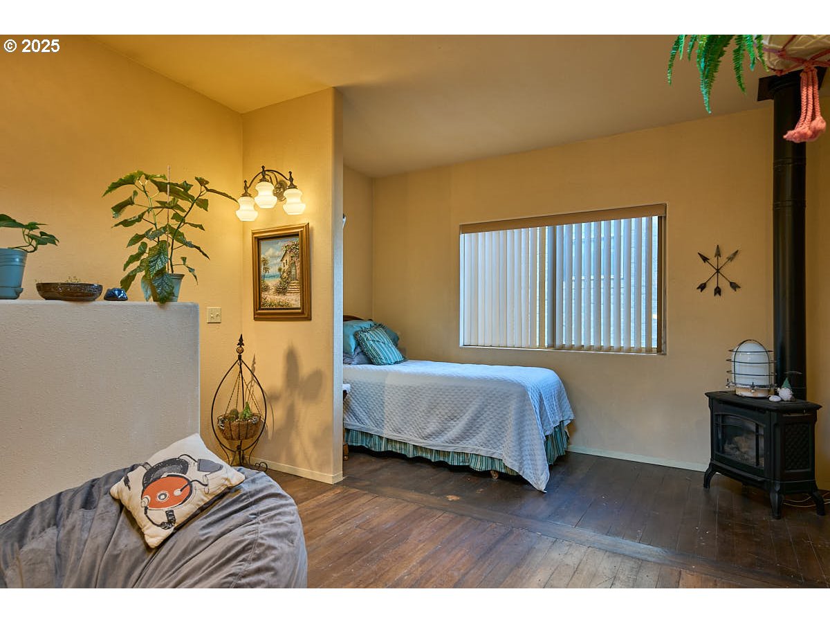 105 East Main Street Enterprise, OR 97828 - Photo 13 of 28 a bedroom with a bed and wooden floor