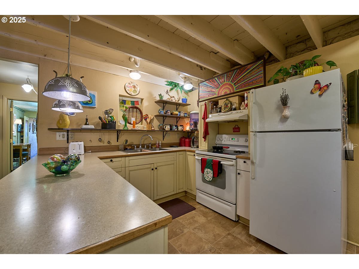 105 East Main Street Enterprise, OR 97828 - Photo 10 of 28 a kitchen with refrigerator and cabinets