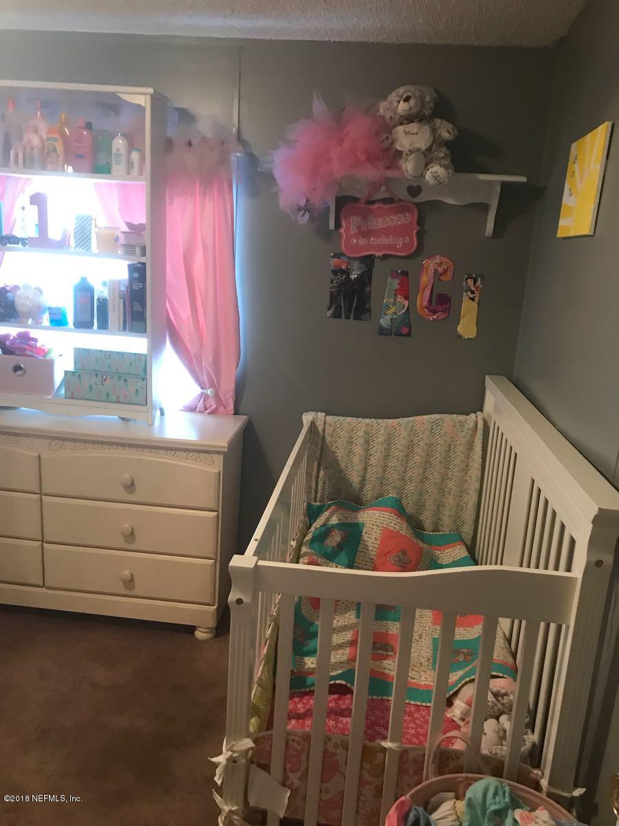 1609 Blair Road Jacksonville, FL 32221 - Photo 11 of 30 a bedroom with furniture and a window