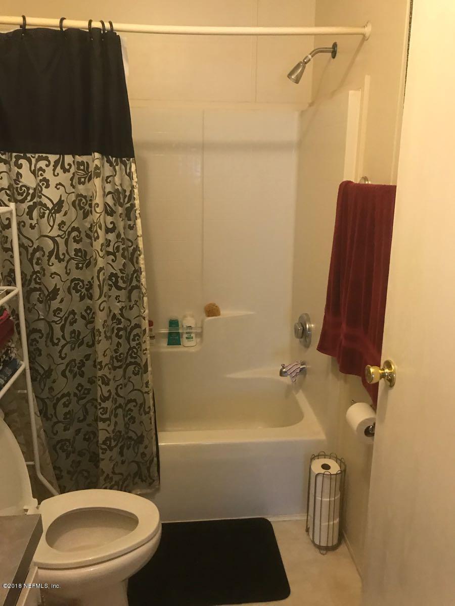 1609 Blair Road Jacksonville, FL 32221 - Photo 17 of 30 a bathroom with a sink and a mirror