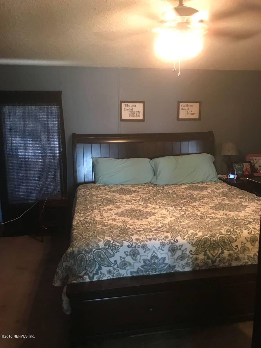 1609 Blair Road Jacksonville, FL 32221 - Photo 18 of 30 a large bed sitting in a bedroom next to a window
