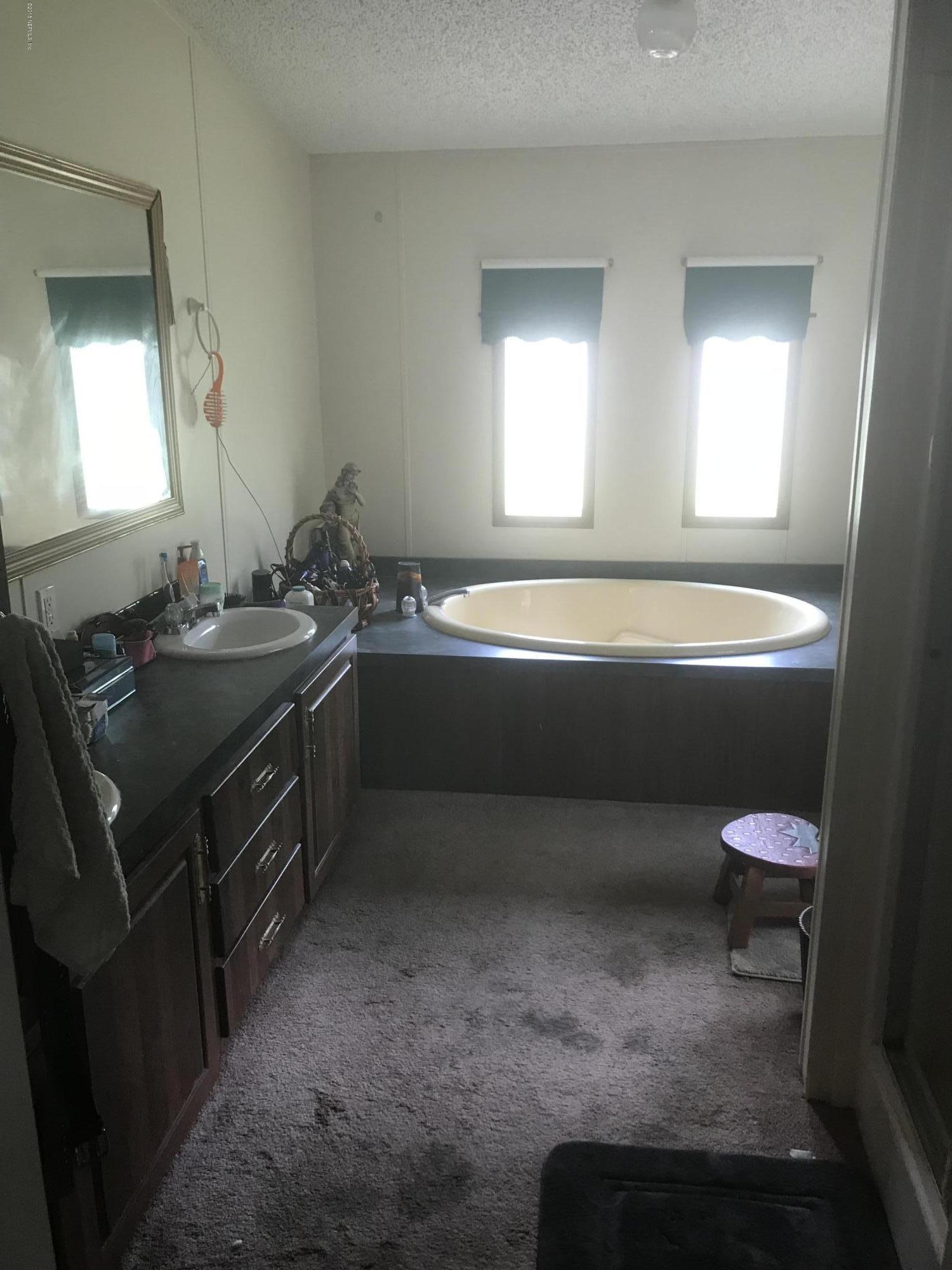 1609 Blair Road Jacksonville, FL 32221 - Photo 20 of 30 a bathroom with a bathtub sink and mirror
