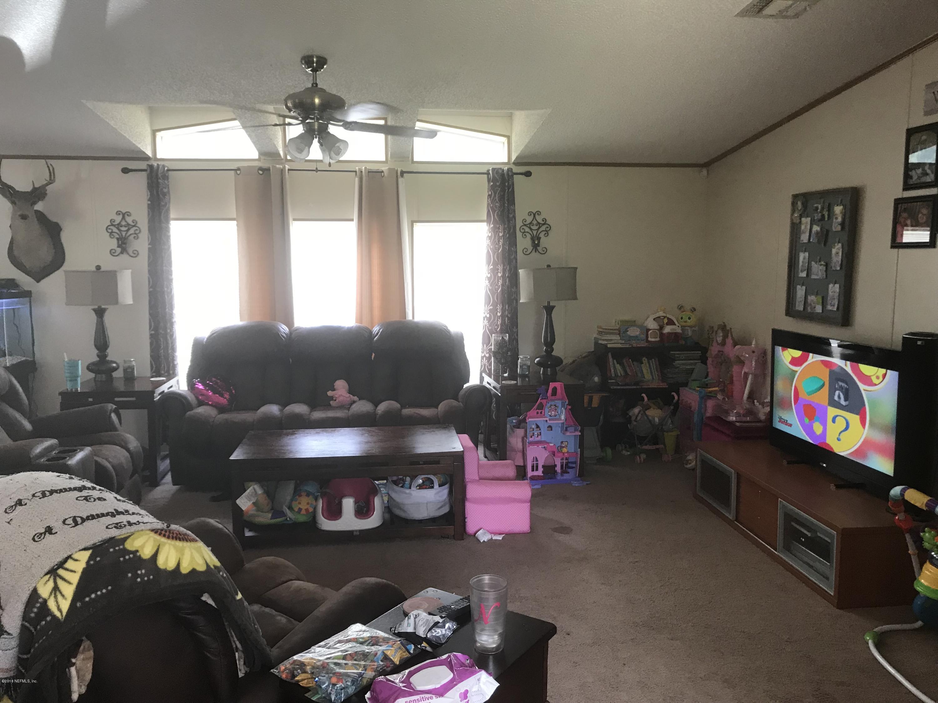 1609 Blair Road Jacksonville, FL 32221 - Photo 2 of 30 a living room with furniture and a chandelier