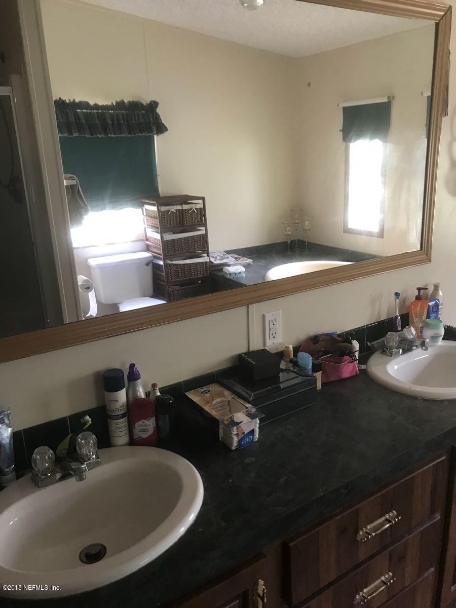 1609 Blair Road Jacksonville, FL 32221 - Photo 21 of 30 a bathroom with a sink and a mirror