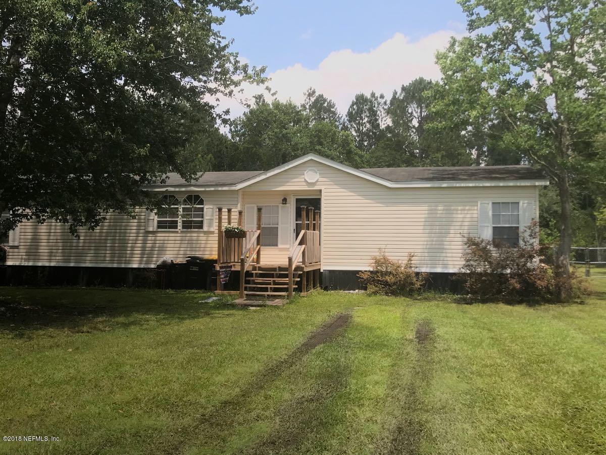 1609 Blair Road Jacksonville, FL 32221 - Photo 26 of 30 a front view of a house with a garden and trees