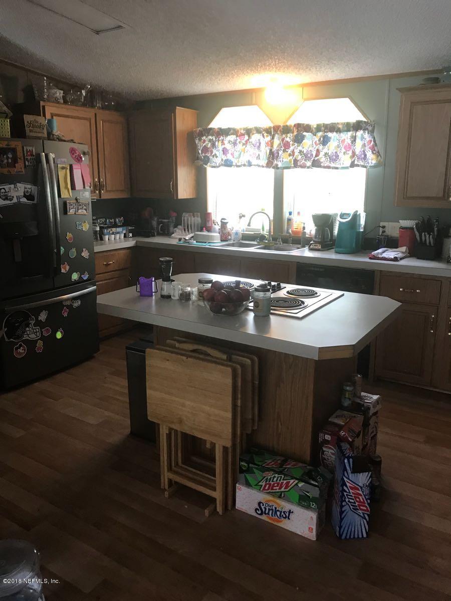 1609 Blair Road Jacksonville, FL 32221 - Photo 8 of 30 a kitchen with a stove a refrigerator and a stove