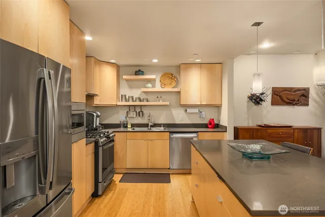a kitchen with stainless steel appliances granite countertop a sink and cabinets