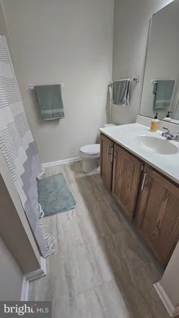 a bathroom with a sink toilet and mirror