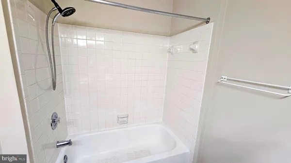 a bathroom with a shower and a bath tub