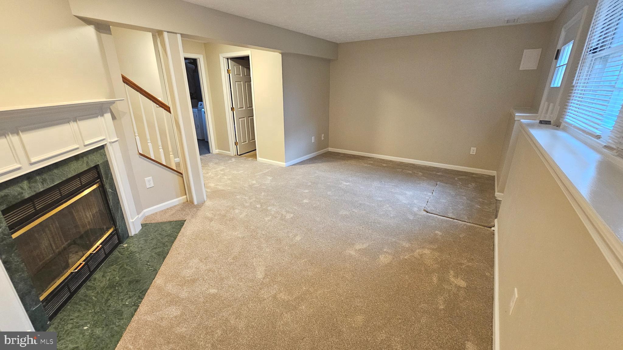1196 Swanhill Court Chestnut Hill Cove, MD 21226 - Photo 27 of 32 a view of an empty room with wooden floor and a kitchen