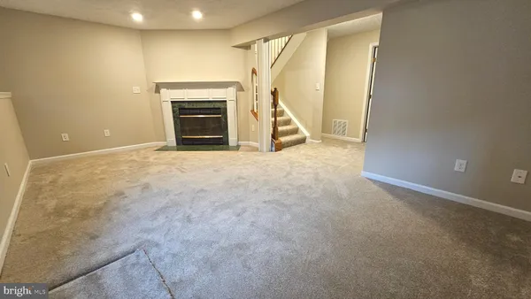 a view of an empty room with a fireplace