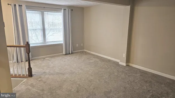 an empty room with a empty space and a window