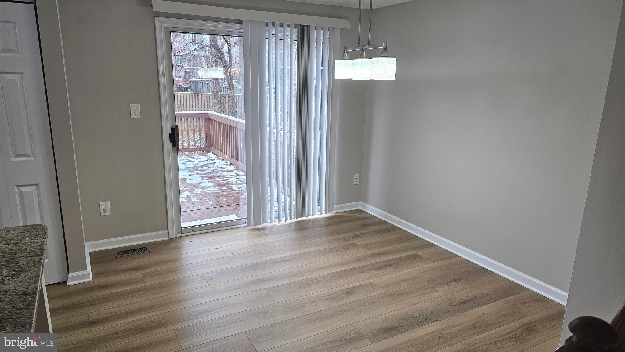 1196 Swanhill Court Chestnut Hill Cove, MD 21226 - Photo 8 of 32 an empty room with wooden floor and windows