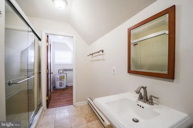 a bathroom with a bathtub sink and mirror