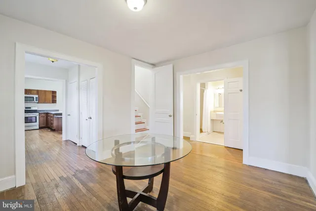 a view of a room with wooden floor and bathroom