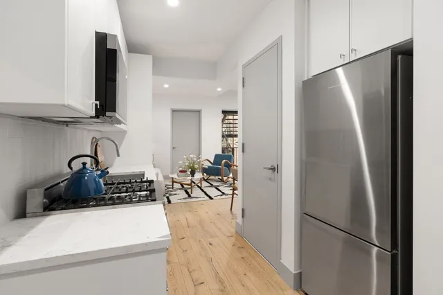 a kitchen with a refrigerator and a sink