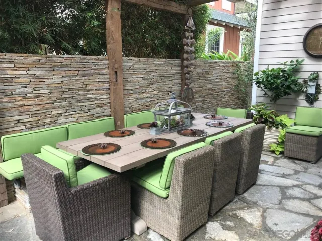 a view of an outdoor sitting area with brick walls