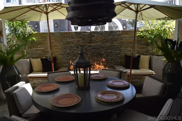 a balcony with table and chairs