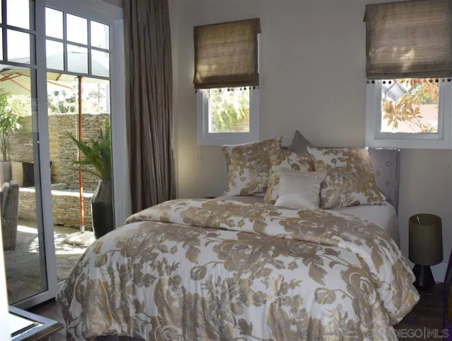 a large bed sitting in a bedroom next to a window