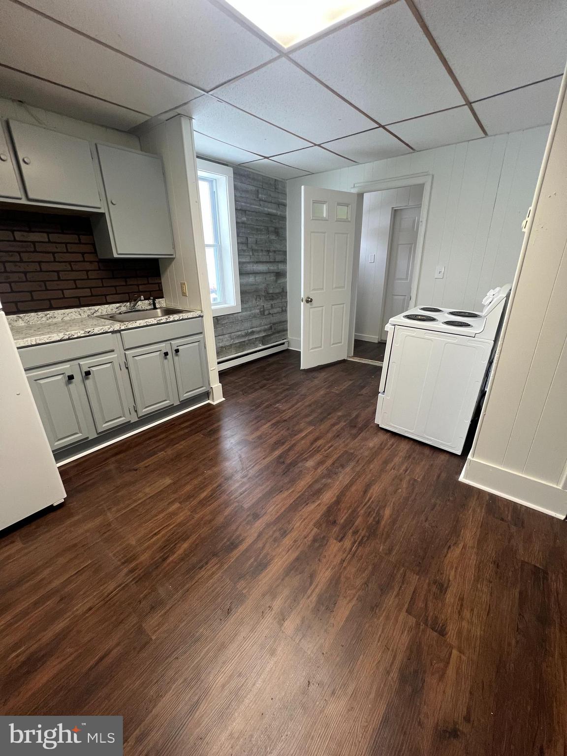 544 North 8th Street, Unit 2 Lebanon, PA 17046 - Photo 2 of 7 a kitchen with stainless steel appliances granite countertop a stove and a wooden floors