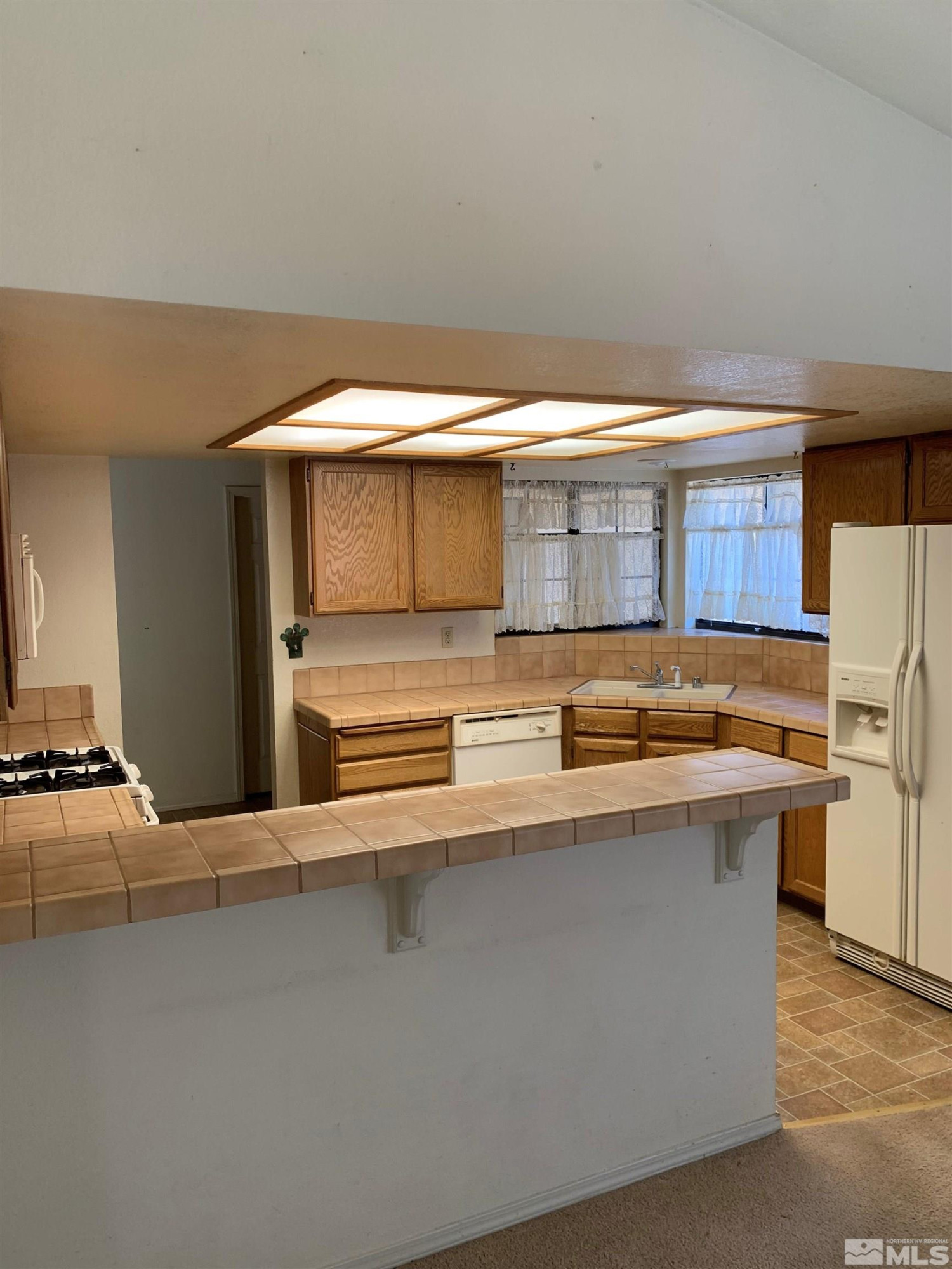 5261 Coit Drive Reno, NV 89523 - Photo 3 of 11 a kitchen with stainless steel appliances a sink a stove and a refrigerator