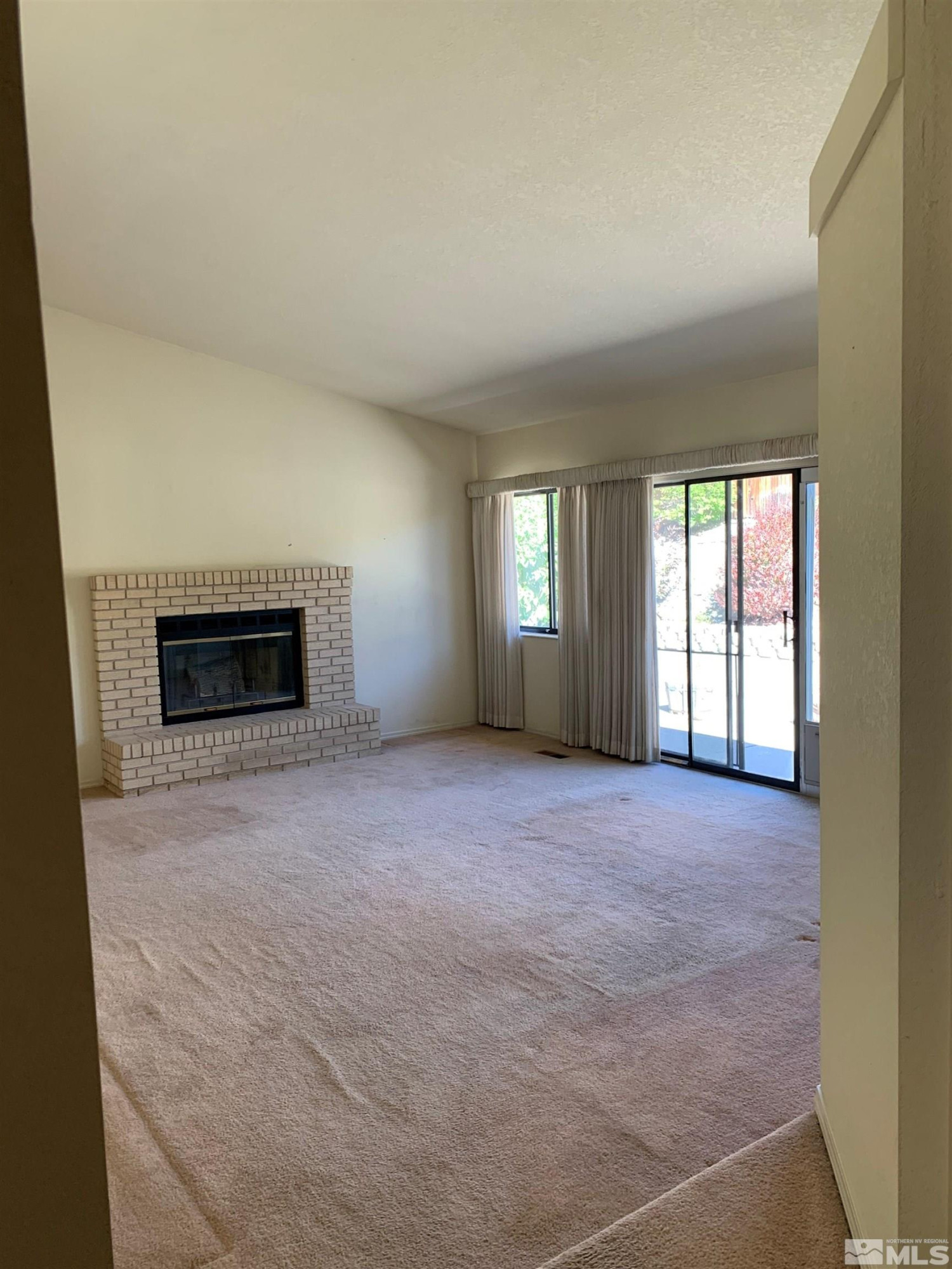 5261 Coit Drive Reno, NV 89523 - Photo 4 of 11 en empty room with windows and fireplace