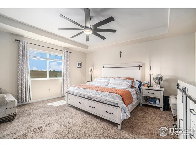 a spacious bedroom with a bed and a window