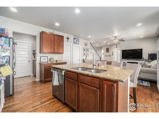 a kitchen with stainless steel appliances granite countertop a sink stove and wooden cabinets