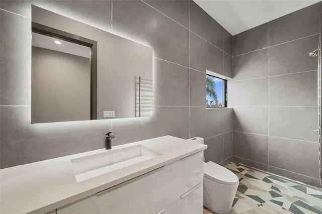 a bedroom with a bed and large window