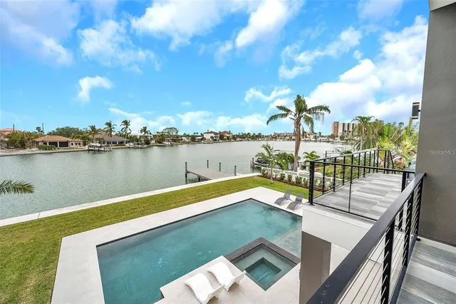 a white house with tree in front of it