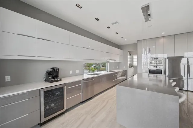 a kitchen with stainless steel appliances granite countertop a refrigerator and a stove top oven