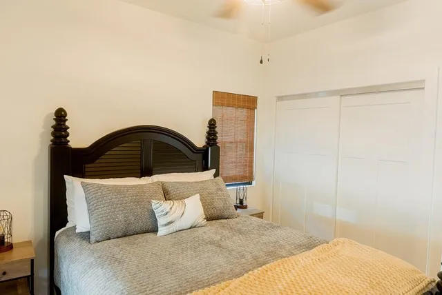 a bedroom with a bed and a window