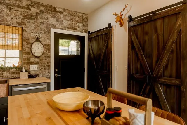 a kitchen with stainless steel appliances granite countertop a refrigerator a stove a sink and a microwave