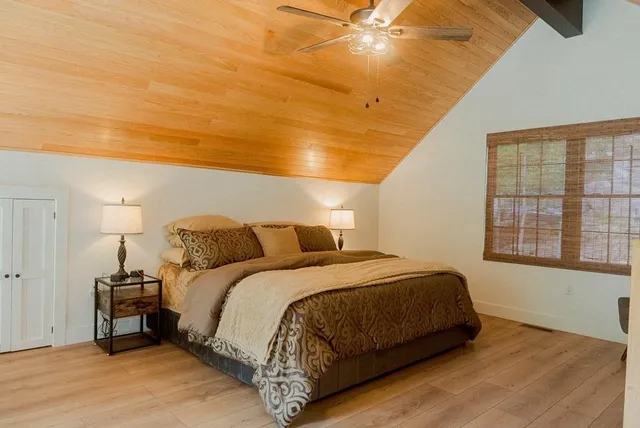 a living room with a bed furniture and a large window