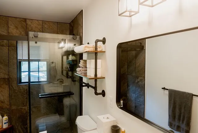 a bathroom with a sink toilet and shower