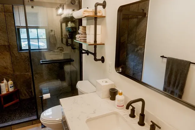 a view of a balcony with chairs and wooden fence
