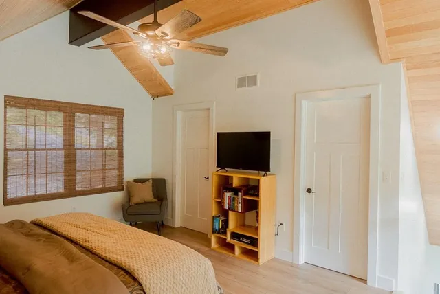 a balcony with wooden floor table and chairs