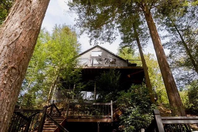 an aerial view of a houses with a lake view