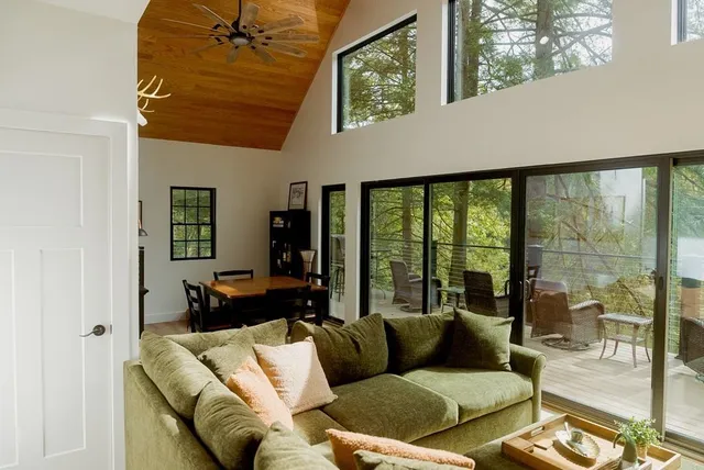 a bedroom with a bed and a black white bedspread