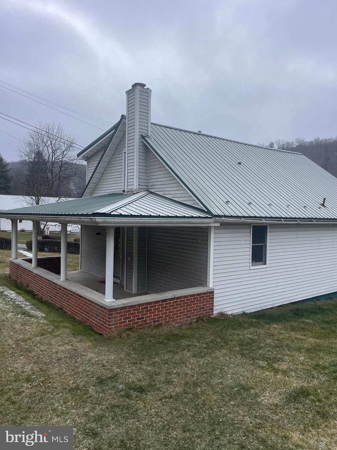 15607 Old Coney Cemetery Road Southwest Lonaconing, MD 21539 - Photo 4 of 34 a front view of a house with a garden