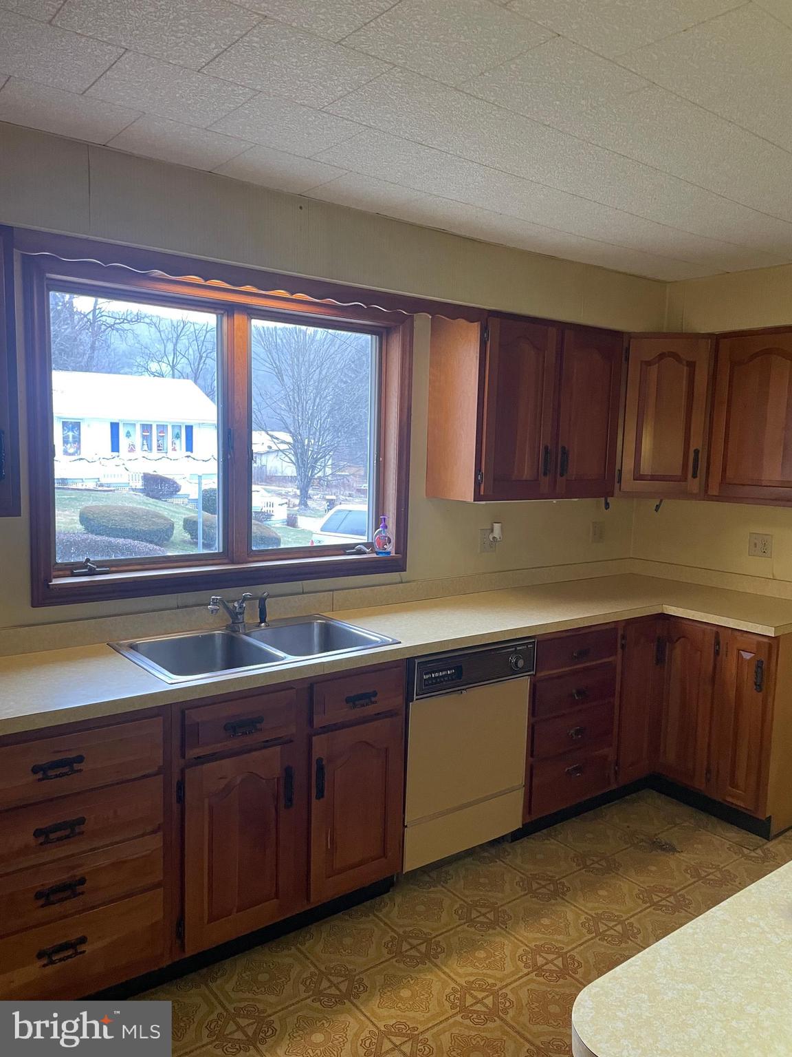 15607 Old Coney Cemetery Road Southwest Lonaconing, MD 21539 - Photo 7 of 34 a kitchen with stainless steel appliances granite countertop wooden cabinets a sink and dishwasher with wooden floor