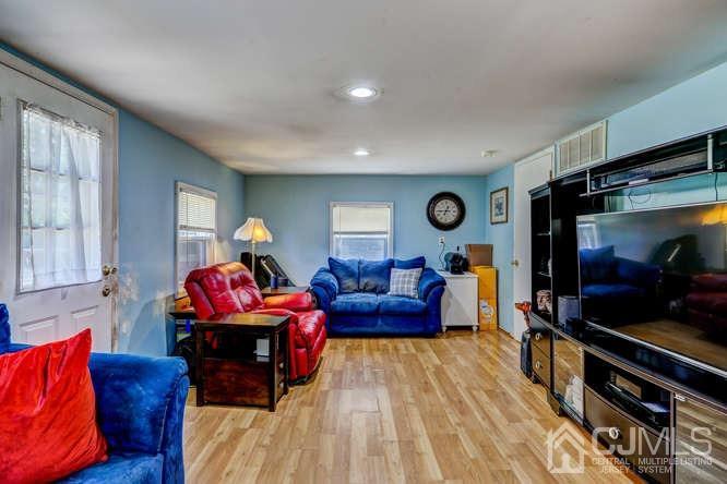 50 Ashley Road Edison, NJ 08817 - Photo 12 of 25 a living room with furniture a flat screen tv and a window