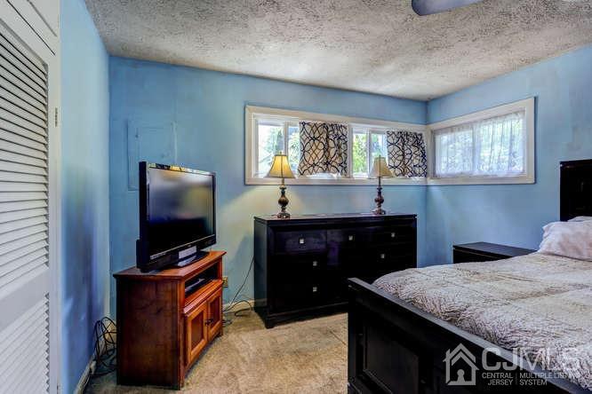 50 Ashley Road Edison, NJ 08817 - Photo 14 of 25 a bedroom with a bed and a flat screen tv