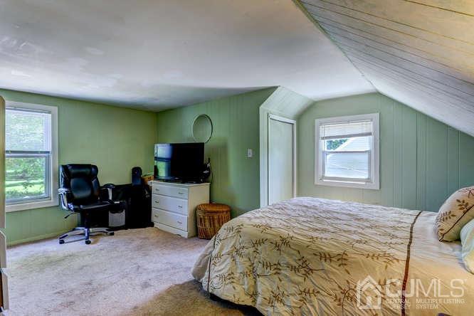 50 Ashley Road Edison, NJ 08817 - Photo 16 of 25 a bedroom with a bed and furniture with a flat tv screen