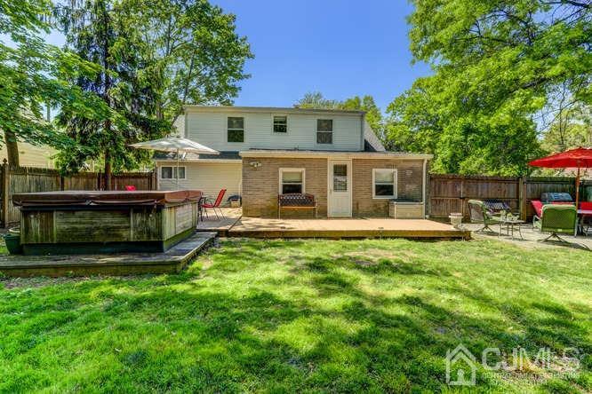 50 Ashley Road Edison, NJ 08817 - Photo 23 of 25 a view of a house with a backyard porch and sitting area