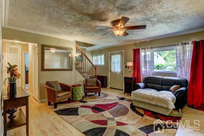 50 Ashley Road Edison, NJ 08817 - Photo 7 of 25 a living room with furniture and a chandelier