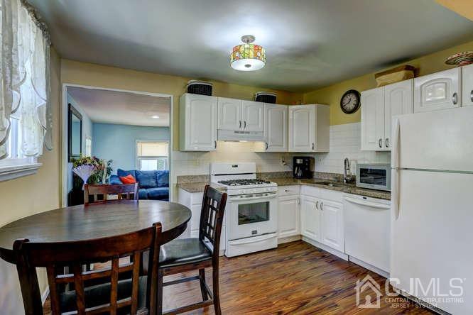 50 Ashley Road Edison, NJ 08817 - Photo 8 of 25 a kitchen with granite countertop stainless steel appliances a dining table and chairs