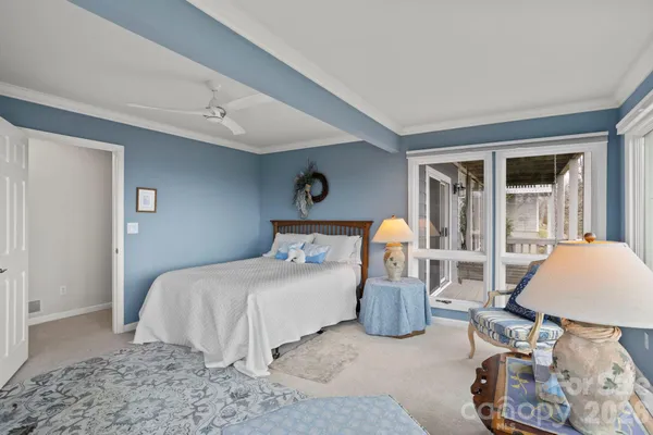 a bedroom with bed and glass door