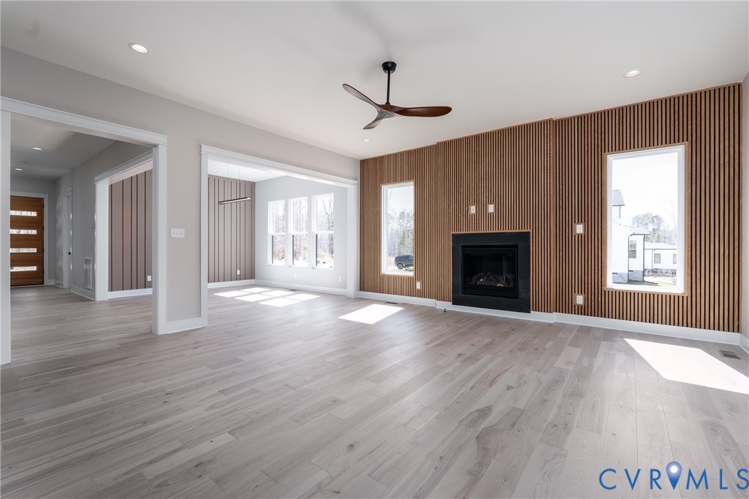 3536 Ampfield Way Midlothian, VA 23112 - Photo 13 of 49 an empty room with wooden floor fireplace and windows