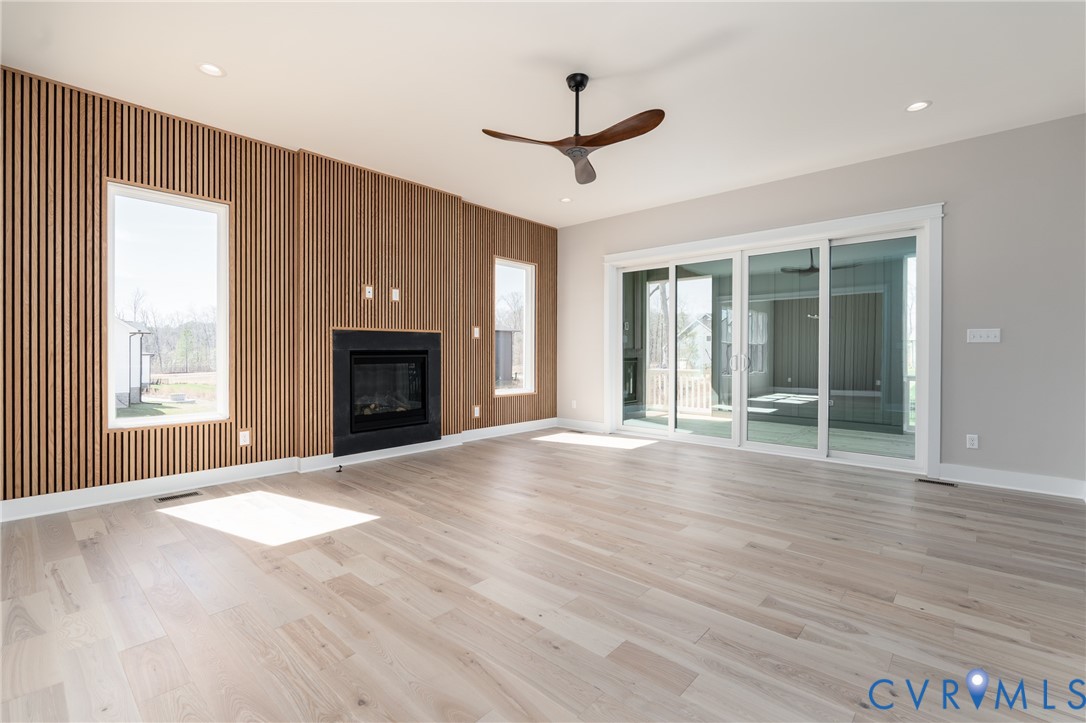 3536 Ampfield Way Midlothian, VA 23112 - Photo 14 of 49 a view of an empty room with wooden floor fireplace and a window